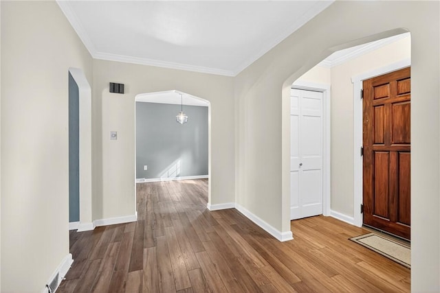112 Oxford Pl, Saint Clair, PA 15241 - entryway featuring arched walkways, crown molding, and wood finished floors