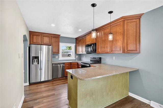 112 Oxford Pl, Saint Clair, PA 15241 - kitchen featuring stainless steel appliances, brown cabinetry, a peninsula, and recessed lighting