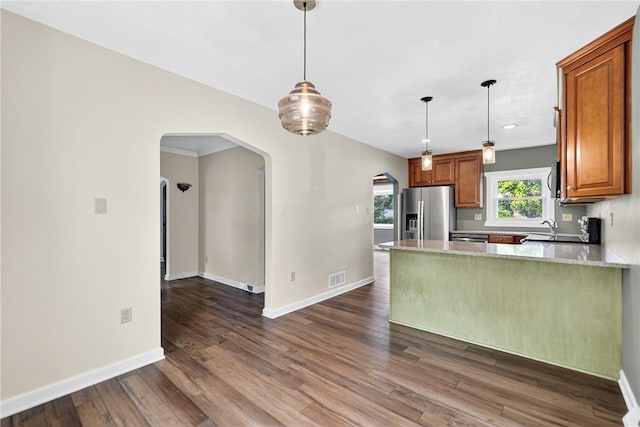 112 Oxford Pl, Saint Clair, PA 15241 - kitchen with appliances with stainless steel finishes, arched walkways, dark wood-type flooring, brown cabinets, and recessed lighting