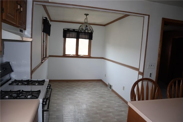 721 Spring St, Roscoe, PA 15477 - kitchen with gas stove, tile patterned floors, crown molding, under cabinet range hood, and light countertops