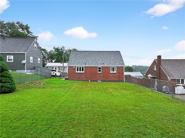 88 Pennsylvania Blvd, Monessen, PA 15062 - back of house with a fenced backyard and brick siding