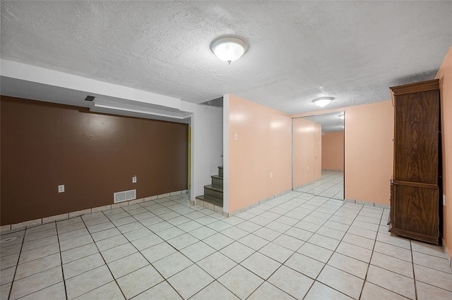 115 Shippingport Rd, Aliquippa, PA 15001 - spare room with a textured ceiling, stairway, and light tile patterned flooring