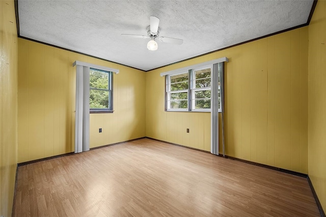 115 Shippingport Rd, Aliquippa, PA 15001 - empty room with wood finished floors, healthy amount of natural light, a ceiling fan, a textured ceiling, and ornamental molding