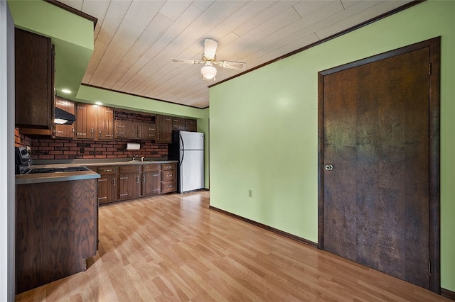 115 Shippingport Rd, Aliquippa, PA 15001 - kitchen featuring freestanding refrigerator, exhaust hood, stove, ceiling fan, and light wood-style flooring