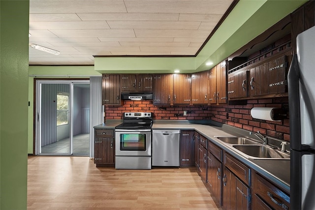 115 Shippingport Rd, Aliquippa, PA 15001 - kitchen featuring appliances with stainless steel finishes, range hood, light wood-type flooring, dark brown cabinetry, and tasteful backsplash