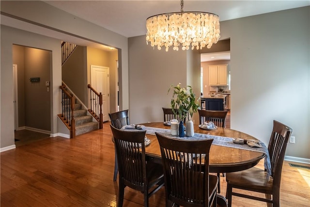 106 Kestler Dr, Pine Twp, PA 15090 - dining area with a chandelier, light wood-style floors, and stairway