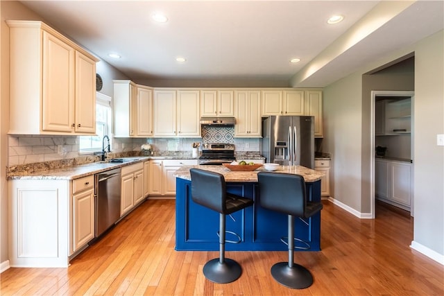 106 Kestler Dr, Pine Twp, PA 15090 - kitchen with stainless steel appliances, under cabinet range hood, light wood-style floors, a kitchen island, and recessed lighting