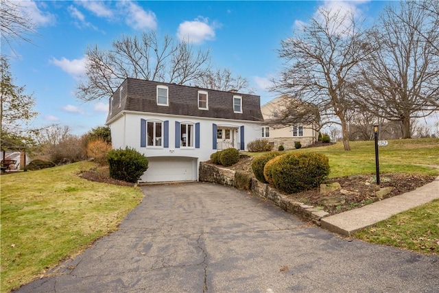 1742 Partridge Run Rd, Saint Clair, PA 15241 - view of front of home with mansard roof, a shingled roof, asphalt driveway, an attached garage, and stucco siding
