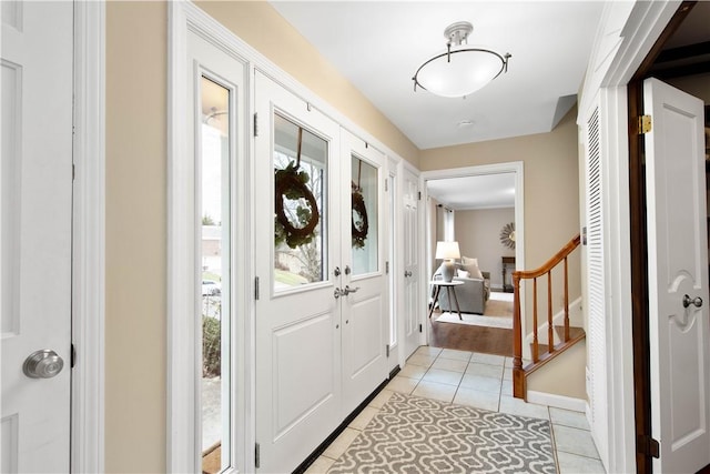 1742 Partridge Run Rd, Saint Clair, PA 15241 - foyer entrance with light tile patterned floors, stairway, and french doors