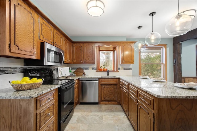 1742 Partridge Run Rd, Saint Clair, PA 15241 - kitchen with stainless steel appliances, a peninsula, and brown cabinets
