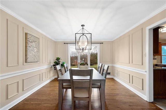 1742 Partridge Run Rd, Saint Clair, PA 15241 - dining room with a decorative wall, a chandelier, crown molding, and dark wood-type flooring