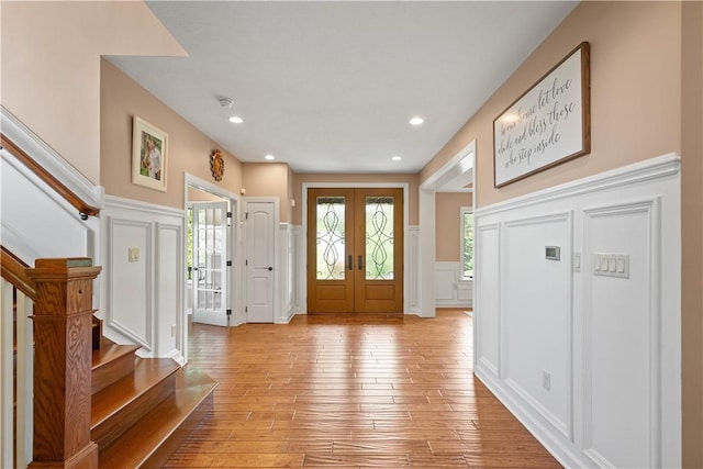 207 Tamarack Dr, Adams Twp, PA 16046 - foyer entrance featuring a decorative wall, french doors, light wood-type flooring, stairway, and a wainscoted wall