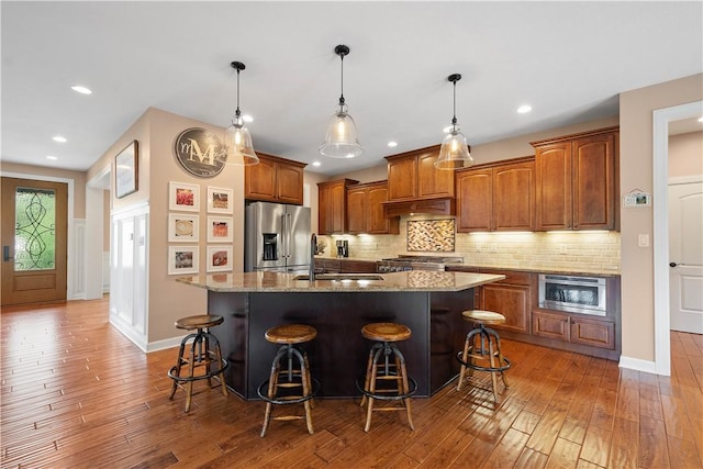 207 Tamarack Dr, Adams Twp, PA 16046 - kitchen featuring stainless steel fridge, light wood-style flooring, light stone countertops, a kitchen breakfast bar, and recessed lighting