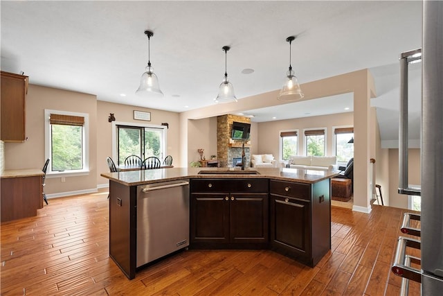 207 Tamarack Dr, Adams Twp, PA 16046 - kitchen featuring stainless steel dishwasher, light wood finished floors, open floor plan, healthy amount of natural light, and recessed lighting