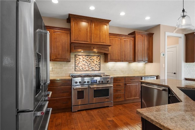 207 Tamarack Dr, Adams Twp, PA 16046 - kitchen with appliances with stainless steel finishes, light stone countertops, hanging light fixtures, dark wood-type flooring, and recessed lighting