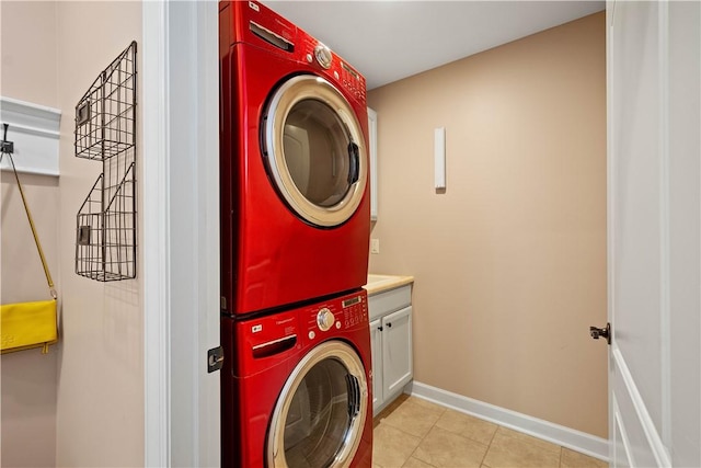207 Tamarack Dr, Adams Twp, PA 16046 - laundry room with stacked washer and clothes dryer, cabinet space, and light tile patterned floors