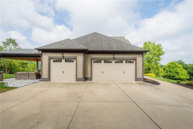 207 Tamarack Dr, Adams Twp, PA 16046 - view of home's exterior featuring driveway, a garage, and roof with shingles