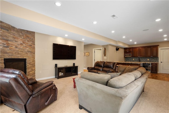 207 Tamarack Dr, Adams Twp, PA 16046 - living room with wine cooler, recessed lighting, light colored carpet, a fireplace, and bar area