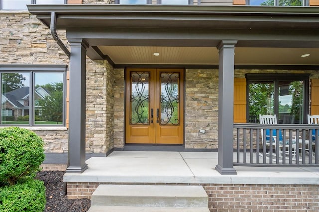 207 Tamarack Dr, Adams Twp, PA 16046 - doorway to property featuring stone siding, french doors, and covered porch