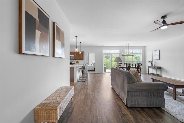 2034 Aiken Ct, Robinson Twp, PA 15136 - living area featuring dark wood finished floors, ceiling fan, and a chandelier