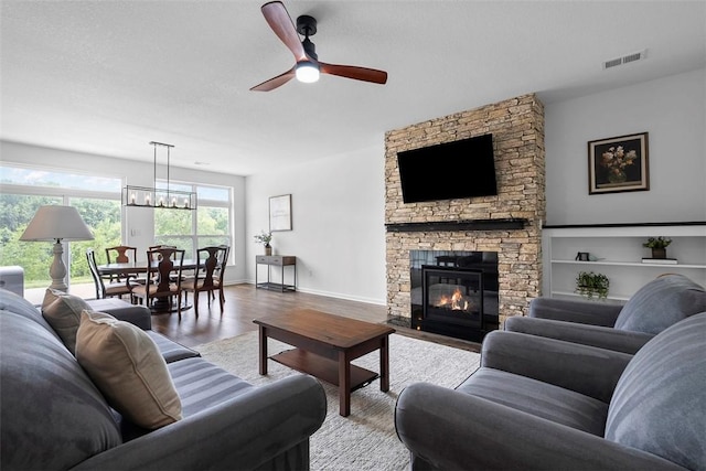 2034 Aiken Ct, Robinson Twp, PA 15136 - living area with wood finished floors, a ceiling fan, and a fireplace