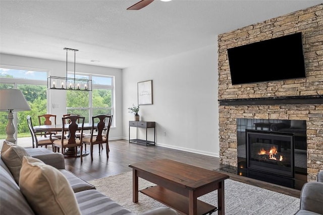 2034 Aiken Ct, Robinson Twp, PA 15136 - living room featuring a chandelier, wood finished floors, ceiling fan, and a fireplace