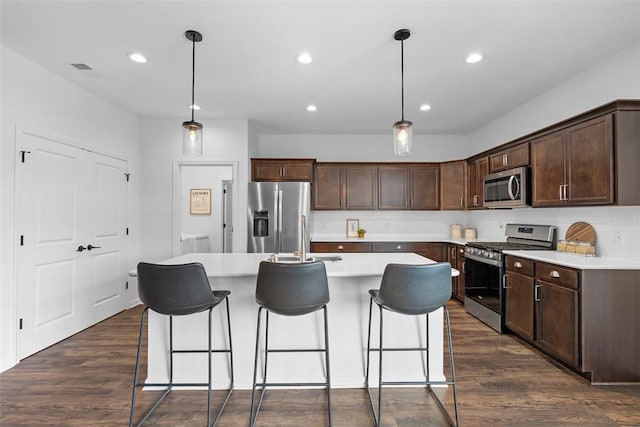 2034 Aiken Ct, Robinson Twp, PA 15136 - kitchen featuring appliances with stainless steel finishes, a kitchen island with sink, dark brown cabinets, light countertops, and recessed lighting