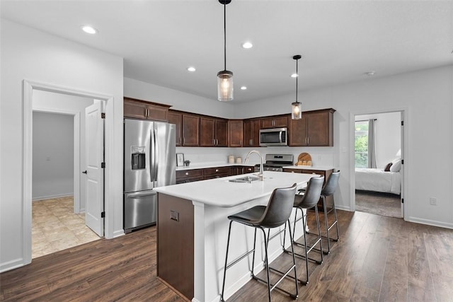 2034 Aiken Ct, Robinson Twp, PA 15136 - kitchen featuring stainless steel appliances, light countertops, dark brown cabinetry, recessed lighting, and dark wood finished floors