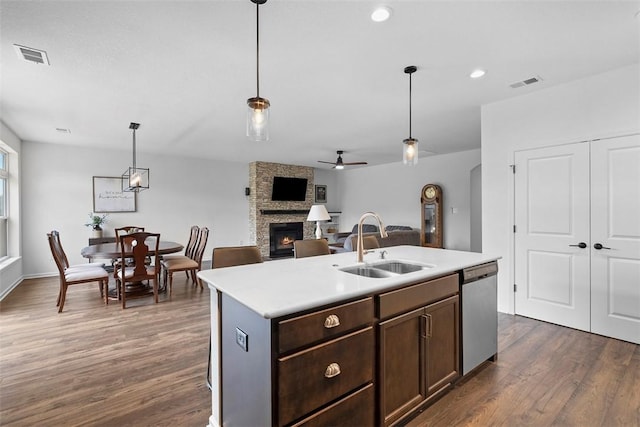 2034 Aiken Ct, Robinson Twp, PA 15136 - kitchen featuring dishwasher, a stone fireplace, light countertops, dark wood-style flooring, and recessed lighting