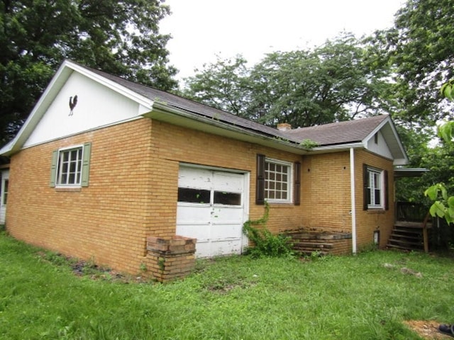 463 Georgetown Rd, South Beaver Twp, PA 16115 - view of side of home featuring brick siding, a garage, and a yard