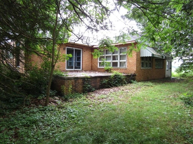 463 Georgetown Rd, South Beaver Twp, PA 16115 - view of side of home featuring brick siding and a lawn