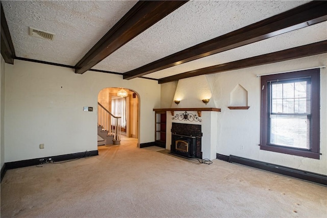 109 Maplewood Ave, Center Twp, PA 15001 - unfurnished living room with carpet flooring, arched walkways, a textured ceiling, stairs, and beam ceiling