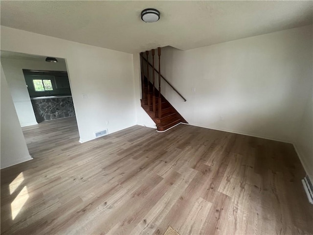 1735 Kimball Ave, New Kensington, PA 15068 - unfurnished living room featuring wood finished floors and stairs