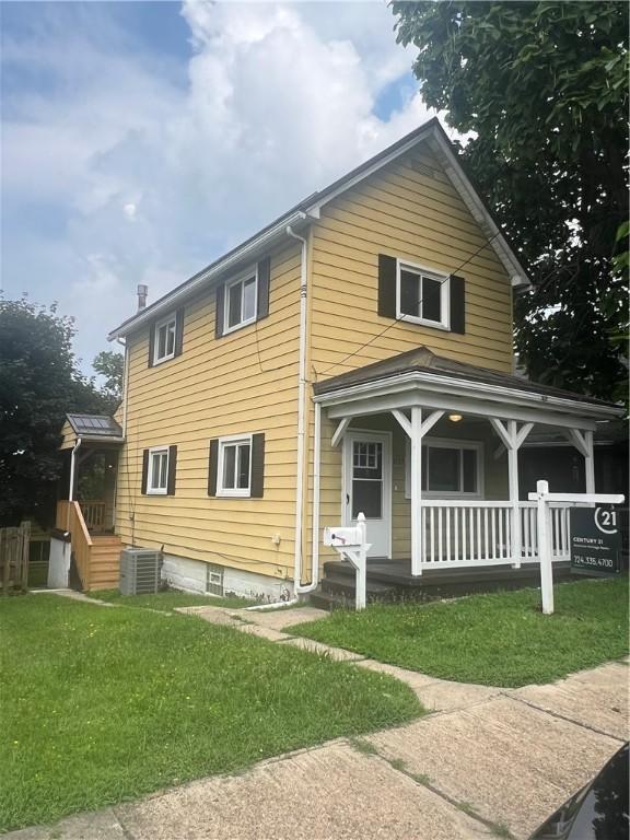 1735 Kimball Ave, New Kensington, PA 15068 - view of front facade featuring a porch and a front lawn