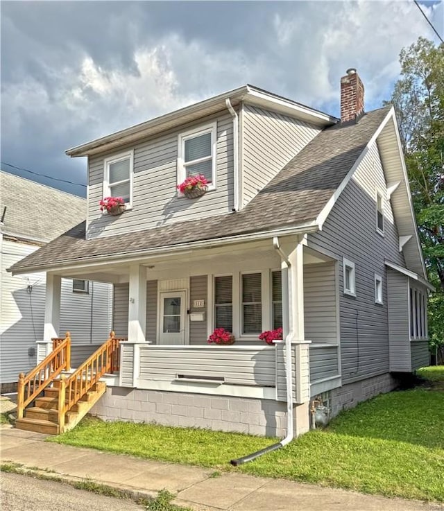 514 Linden Ave, New Kensington, PA 15068 - bungalow-style home featuring a porch, a chimney, roof with shingles, and a front lawn