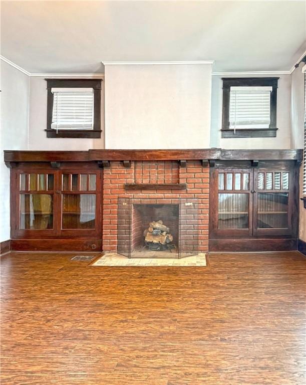 514 Linden Ave, New Kensington, PA 15068 - unfurnished living room featuring crown molding, wood finished floors, and a brick fireplace