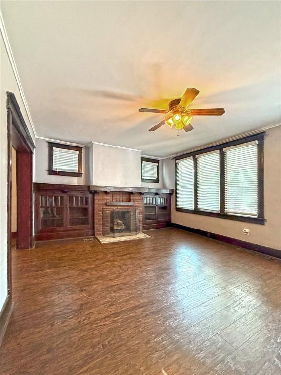 514 Linden Ave, New Kensington, PA 15068 - unfurnished living room with a fireplace, crown molding, ceiling fan, and wood finished floors
