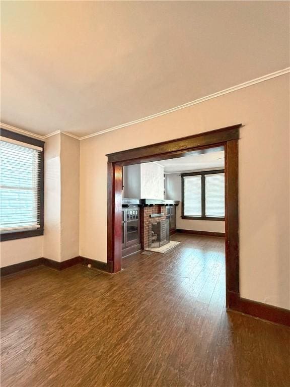 514 Linden Ave, New Kensington, PA 15068 - unfurnished living room with dark wood-type flooring, crown molding, and a fireplace