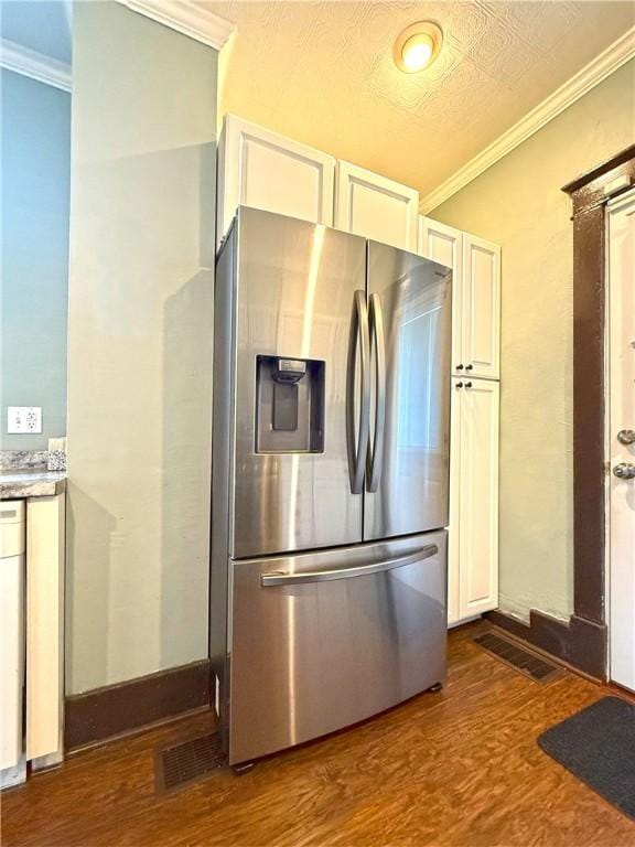514 Linden Ave, New Kensington, PA 15068 - kitchen featuring stainless steel refrigerator with ice dispenser, dark wood finished floors, crown molding, white cabinets, and light countertops