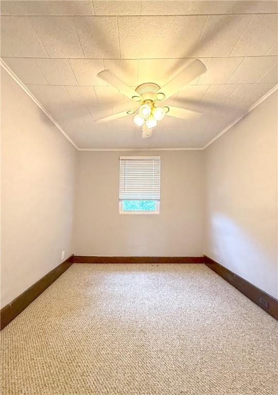 514 Linden Ave, New Kensington, PA 15068 - spare room featuring light colored carpet, crown molding, and ceiling fan