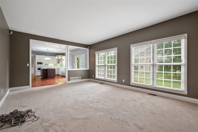 801 Huron Ct, Adams Twp, PA 15044 - unfurnished living room with light carpet and a chandelier