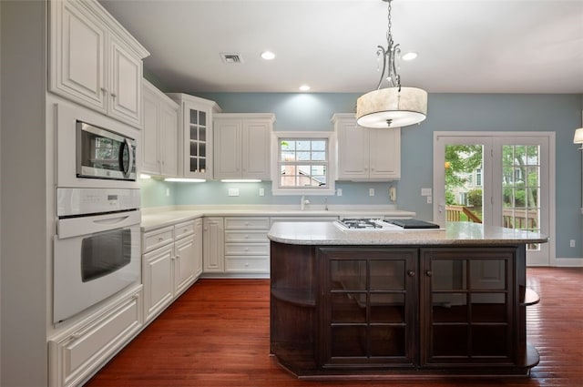 801 Huron Ct, Adams Twp, PA 15044 - kitchen featuring oven, stainless steel microwave, gas stovetop, white cabinetry, and recessed lighting