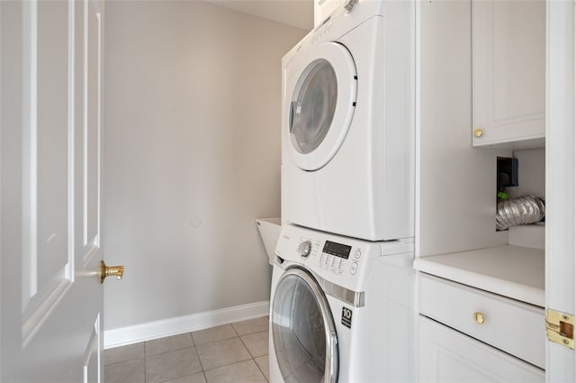 801 Huron Ct, Adams Twp, PA 15044 - laundry room featuring cabinet space, estacked washer and dryer, and light tile patterned floors