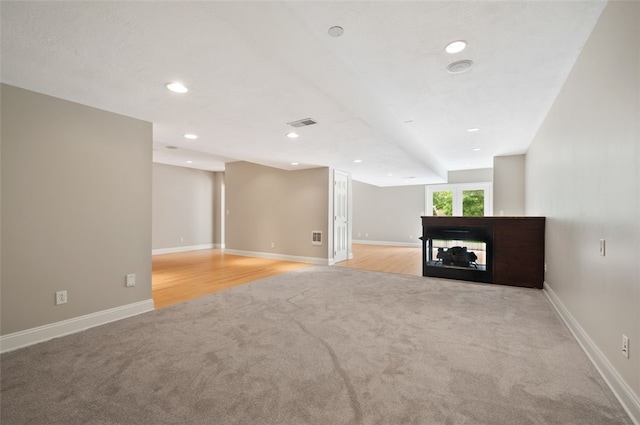 801 Huron Ct, Adams Twp, PA 15044 - unfurnished living room featuring light carpet, a multi sided fireplace, and recessed lighting