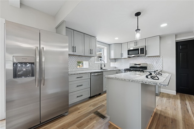 327 Charles Ave, New Kensington, PA 15068 - kitchen featuring stainless steel appliances, gray cabinets, decorative backsplash, and recessed lighting