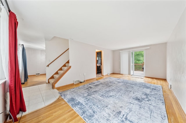 1541 Sugarloaf, Plum Boro, PA 15239 - unfurnished living room featuring stairway and wood finished floors