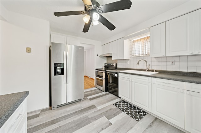 1541 Sugarloaf, Plum Boro, PA 15239 - kitchen featuring stainless steel appliances, dark countertops, light wood finished floors, white cabinetry, and tasteful backsplash