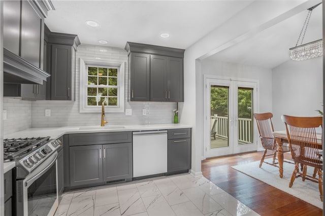 231 Loretta Dr, Monroeville, PA 15146 - kitchen with dishwasher, stainless steel gas range oven, light countertops, light marble finish floors, and tasteful backsplash