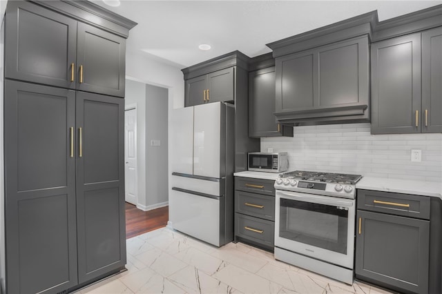 231 Loretta Dr, Monroeville, PA 15146 - kitchen featuring appliances with stainless steel finishes, light marble finish flooring, light countertops, and decorative backsplash