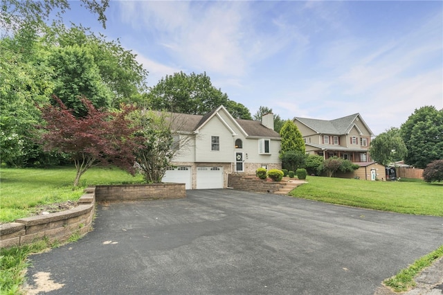 231 Loretta Dr, Monroeville, PA 15146 - split foyer home featuring driveway, a garage, a chimney, and a front lawn